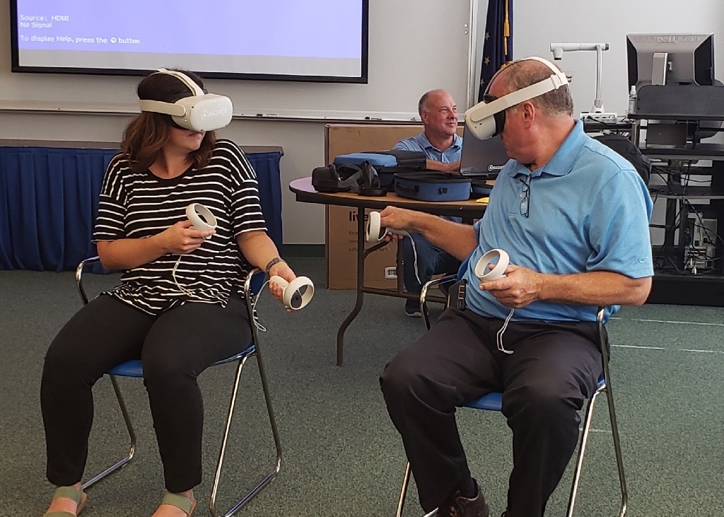 Lindsey and Larry are exploring different VR worlds using headsets. 