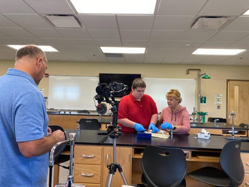 Jim Bisesi recording video of a student and instructor dissecting sheep brains for a VR campus tour. 